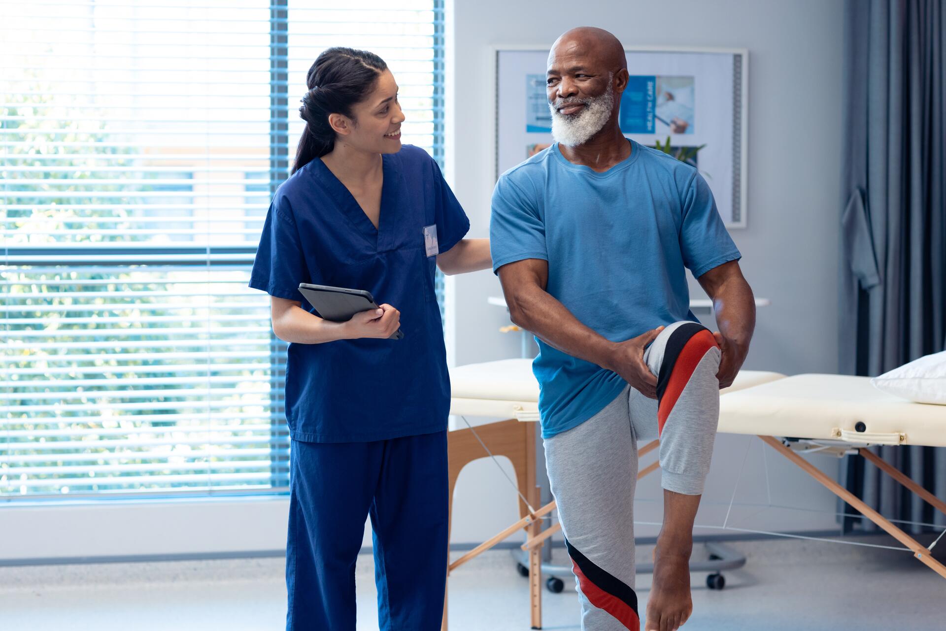 A physiotherapist assisting a patient with stretching